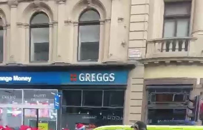 Masked Rangers fan squares up to police before punching van as huge group of ultras in SANTA HATS march to Celtic game