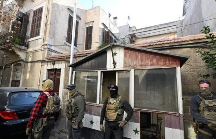 the tricolor flag hoisted over the French embassy in Damascus