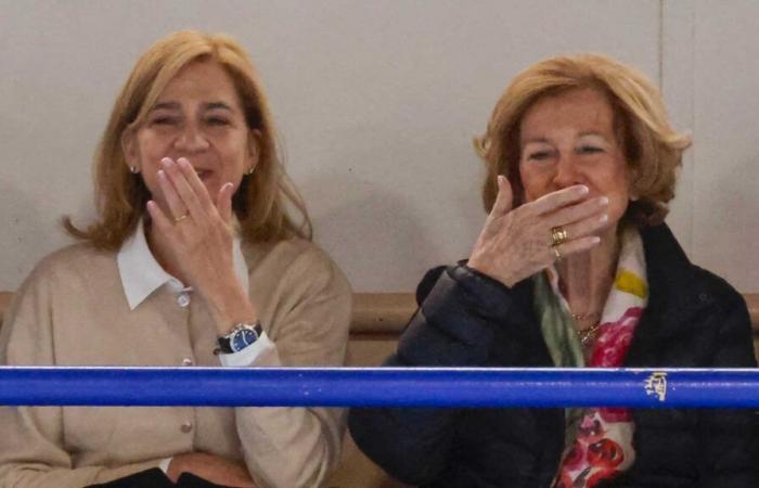 Queen Sofia tenderly encourages her grandson Pablo during his handball match