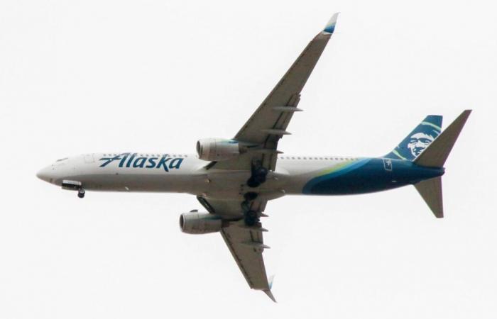 After landing, a passenger sits on the wing of the plane for more than ten minutes