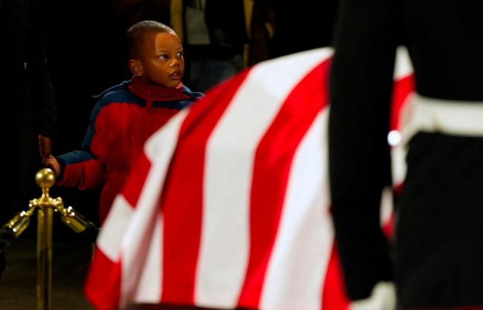 In Atlanta, supporters of Jimmy Carter crowd around his coffin for a final farewell