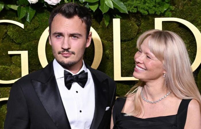 Pamela Anderson appears on the arm of her son Thomas Lee on the Golden Globes red carpet