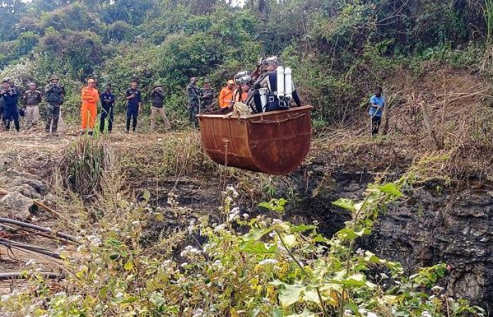 rescuers try to reach miners trapped underground by flood