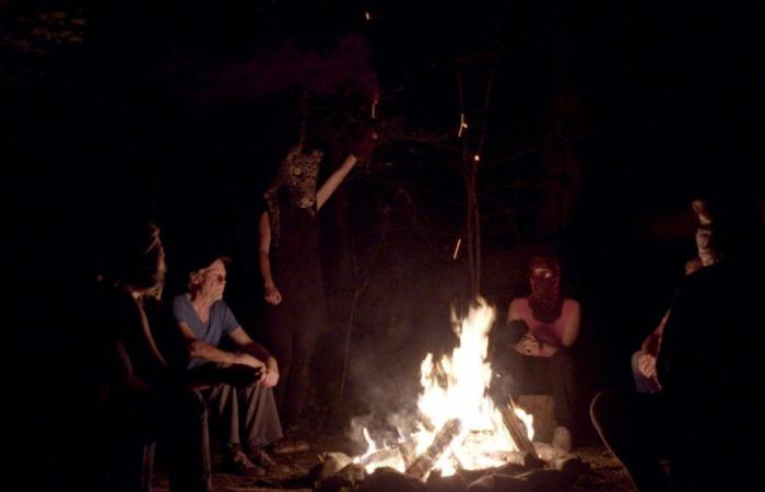 Former members of the Fasel Gang and Extinction Rebellion activists gathered around the fire