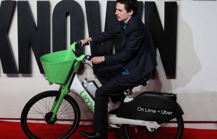 when actor Timothée Chalamet arrives by bike on the red carpet in London