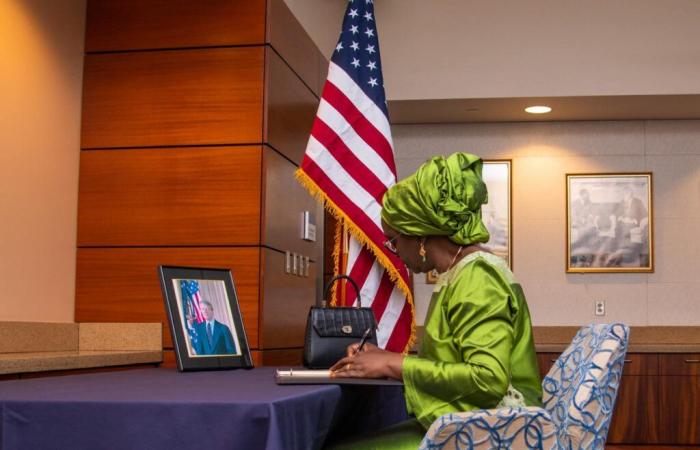 Yassine Fall signs the register of condolences at the United States Embassy in Dakar