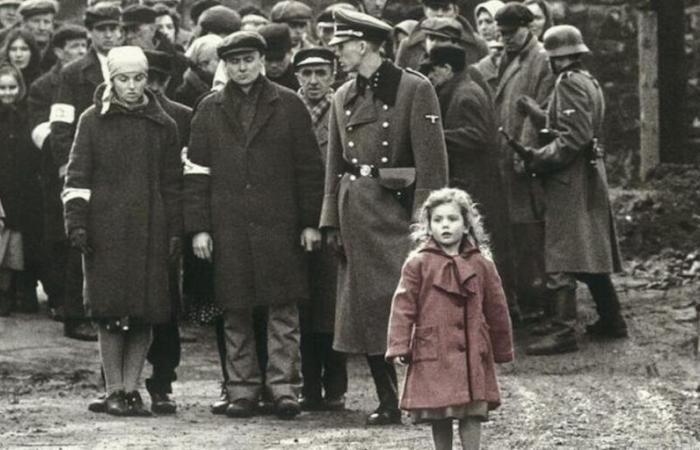 why is the little girl in the coat in red in this black and white film?