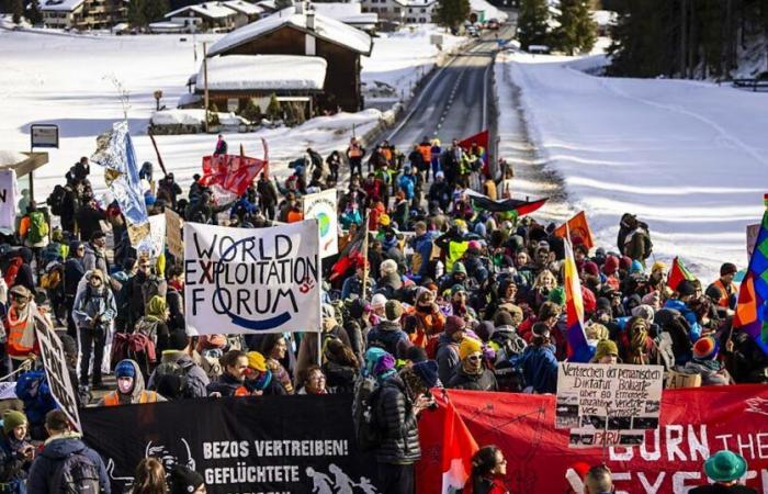 Police force WEF demonstrators off the road