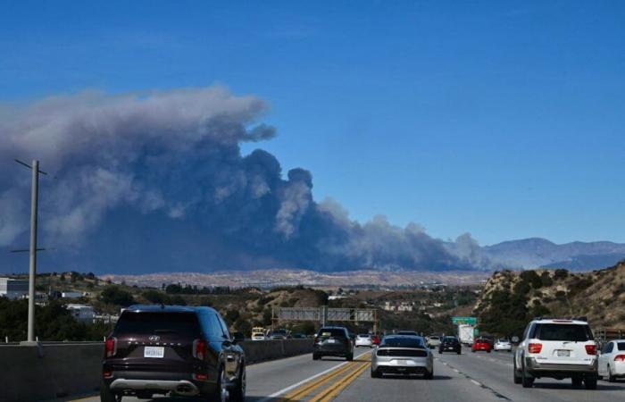 A new fire rages north of the city