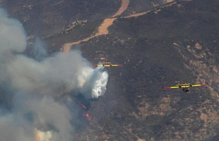 firefighters progress despite strong winds, expected rain