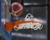 Basketball player smashes basket and glass backboard with dunk, game stopped