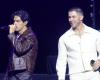 A laser points at his head, Nick Jonas rushes off the stage