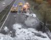 a police officer and a gendarme extricate a driver before his truck explodes