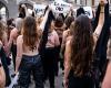 Femen activists demonstrate in front of the Louvre pyramid