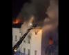 two people defend themselves from a window to escape from a burning squat known for its dilapidation