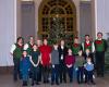 Surrounded by her grandchildren, Silvia from Sweden receives Christmas trees